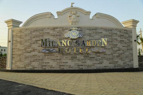 a brick building with a sign that reads mittomo no garden hotel at Milano Garden Plaza Samarkand in Samarkand