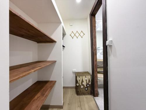 a staircase in a house with white walls and wooden floors at Kiketi Paradise 2 in Kiketʼi