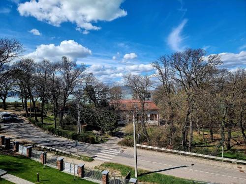 a view of a cemetery with a building and trees at Edison Villa 313 in Fonyód