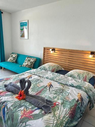 a bedroom with a bed with a turkey on it at Suite Caraïbe vue mer in Le Diamant