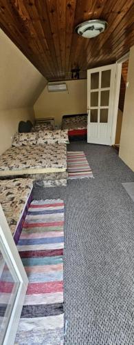 a room with a bed with a rug on the floor at Vadrózsa Apartman Tisza-Tó Poroszló in Poroszló