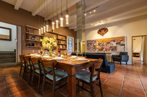 a dining room with a large wooden table and chairs at Casa Feliz Jacuzzis Alberca Gimnacio Vapor PingPong Billar Cuarto de Video in San Miguel de Allende