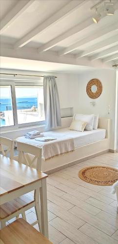 a bedroom with a large bed with a view of the ocean at Tinos Heritage Agora in Tinos