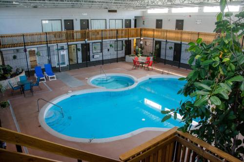 a large swimming pool in a building at Ramada by Wyndham Medicine Hat in Medicine Hat
