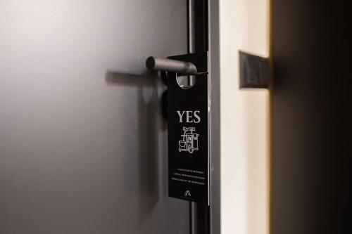 a black door tag is hanging on a door at Alphabet Apartments - Binnenrotte 102 in Rotterdam