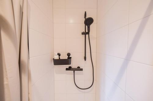 ロッテルダムにあるAlphabet Apartments - Binnenrotte 102のシャワーヘッド付きのシャワー付きのバスルーム