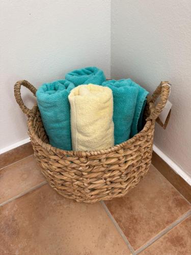 a basket filled with towels sitting on the floor at Caribbean Zen at Bosque Del Mar - Las Picuas - Rio Grande in Rio Grande