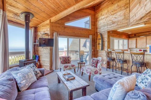 a living room with a blue couch and chairs at A Beachfront Fantasea in Lincoln City