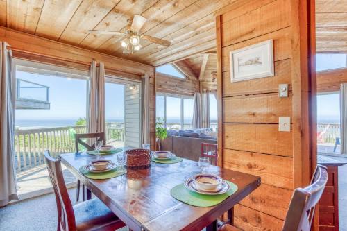 a dining room with a table and a view of the ocean at A Beachfront Fantasea in Lincoln City