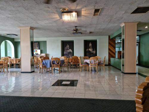 a dining room with chairs and tables in a building at Parador del Río by Flamingo Hotels Group in Irapuato