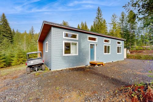 a tiny house in the middle of a forest at River Time Retreat in Carson