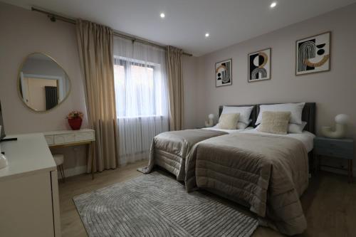 a bedroom with a bed with a mirror and a rug at NEW-BUILD Luxury House for Families and Contractors, NamisSuites Serviced Apartment - Farnborough in Farnborough