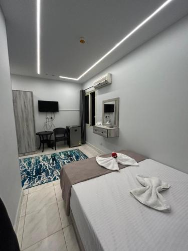a bedroom with a bed with towels on it at Garden City Hotel Downtown in Cairo
