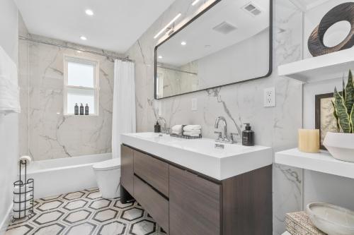 a white bathroom with a sink and a tub at 3BR2Bth TD Garden BOS MIT Harvard 2 Parking Spaces in Somerville