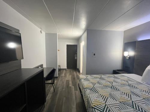 a hotel room with a bed and a desk at Motel 6 Chicago, IL - Halsted in Chicago