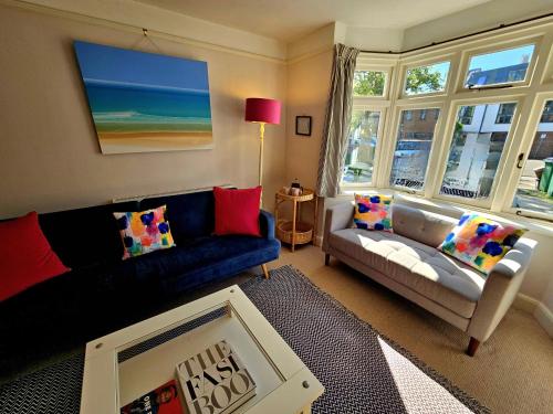 a living room with a couch and a table at Prospect Cottage in Hythe