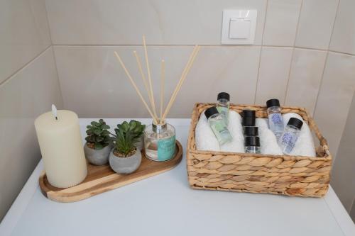 a basket with toiletries and a candle on a counter at Kyma Luxury Home in Pogoniá