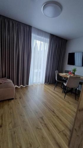 a living room with a table and a dining room at SeasideSpa appartment Jakuzzi Swimming pool in Palanga