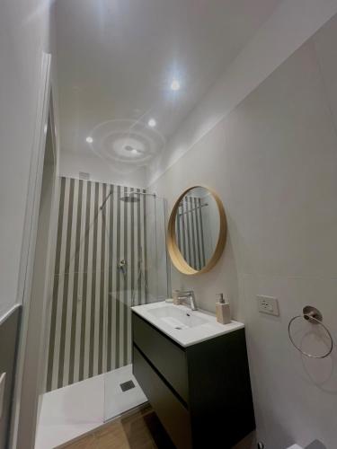 a bathroom with a sink and a shower with a mirror at Cledo Mare Luxury Stay - Armonia in Pescara