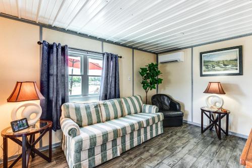 a living room with a couch and a window at Sunrise Landing: Waterfront Cottage in Avenue! in Avenue