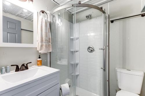 a bathroom with a shower and a sink and a toilet at Sunrise Landing: Waterfront Cottage in Avenue! in Avenue