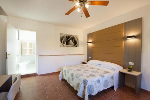 a bedroom with a bed and a ceiling fan at Antica Melegnano in Atri