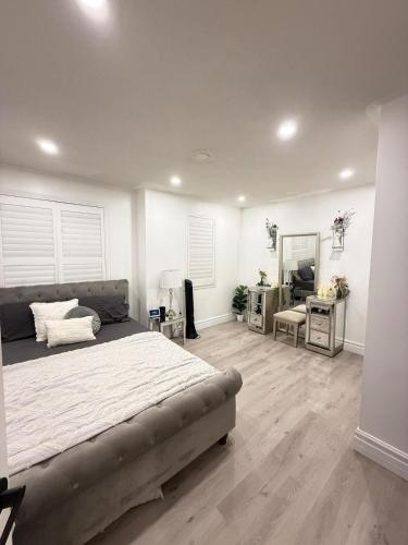 a bedroom with a bed and a desk and a mirror at Welcome to Your Home Away From Home! in Mississauga