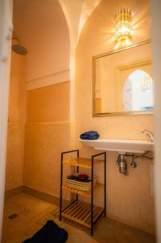 a bathroom with a sink and a mirror at Luxueuse villa VALERIA avec gouvernante in Chaibate