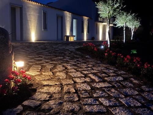 a stone pathway in front of a house at night at Tenuta Paltusa in Calangianus