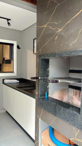 a kitchen with a marble counter top in a room at Casa Joinville in Joinville