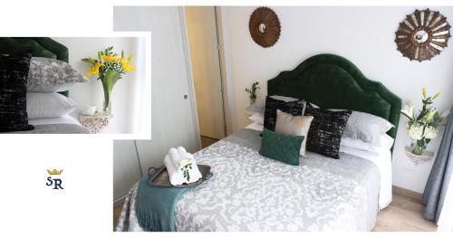 a bedroom with a bed with a green headboard and pillows at MONTFORT Suite Royale Stylish Location with View to Bogotá's historical Church in Bogotá