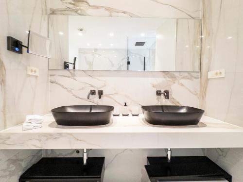 a bathroom with a black sink and a mirror at Casa Cappello in Hvar