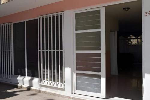 a building with white doors and windows on it at LA CASA de los RIVAS, AA, amplia, cómoda, céntrica in Tepic