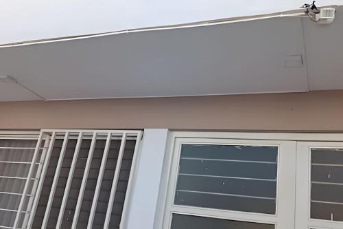 a building with a garage door and a security system at LA CASA de los RIVAS, AA, amplia, cómoda, céntrica in Tepic