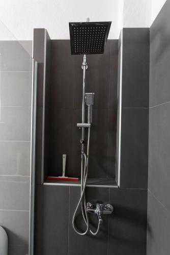 a shower with a shower head in a bathroom at Casa Marjardin Hanioti 2025 in Hanioti