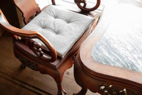 a wooden chair with a pillow on a bed at Megijima Ote no Yado - Vacation STAY 03739v in Takamatsu