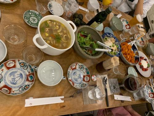 a wooden table with plates of food and a bowl of soup at Megijima Ote no Yado - Vacation STAY 03739v in Takamatsu