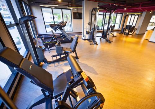 a gym with a bunch of exercise bikes in a room at Urbà Home Stay by Housi in Goiânia