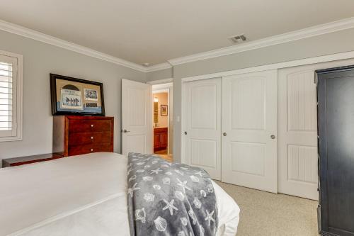a bedroom with a bed and a dresser in it at Chic Coastal Home with Outdoor Oasis in Oxnard! in Oxnard