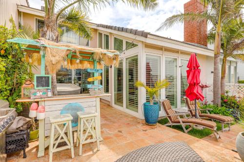 a home with a patio with a bar and chairs at Chic Coastal Home with Outdoor Oasis in Oxnard! in Oxnard