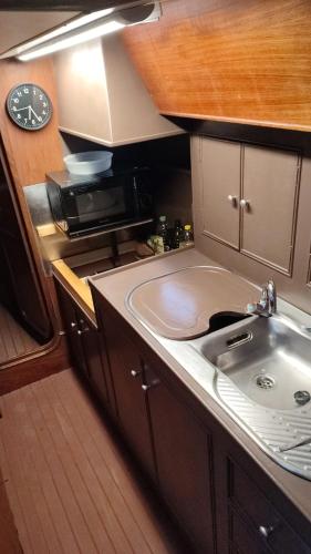 a kitchen with a sink and a microwave at Romantic sailboat in Valencia