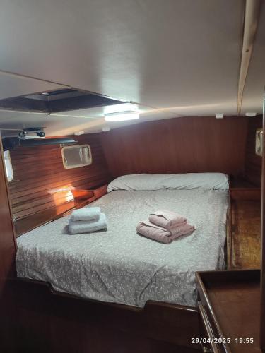 瓦伦西亚Romantic sailboat的一张铺着两条毛巾的床
