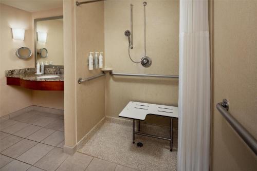 a bathroom with a shower and a sink at Hilton Garden Inn Portland Downtown Waterfront in Portland