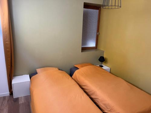 - 2 lits dans une chambre avec 2 oreillers dans l'établissement Le 24 carat appartement 3 pièces neuf, à Beaurepaire