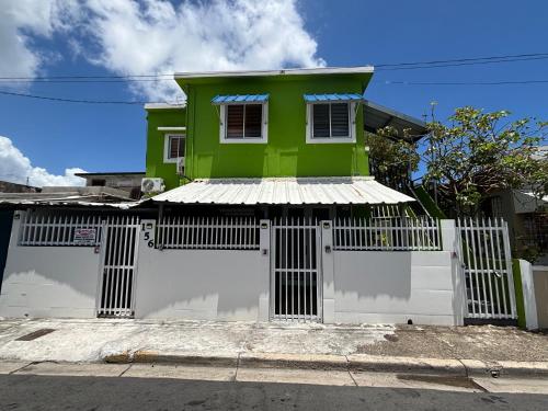 a green and white house with a white garage at Salo-casa Verde 4 Bdrm House By Stay Here Pr in San Juan