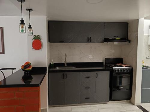 a kitchen with a sink and a stove at Home Sweet Home Luxury Paipa in Paipa
