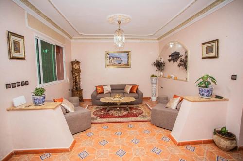 a living room with a couch and a table at Luxurious, spacious, and family villa in M'diq