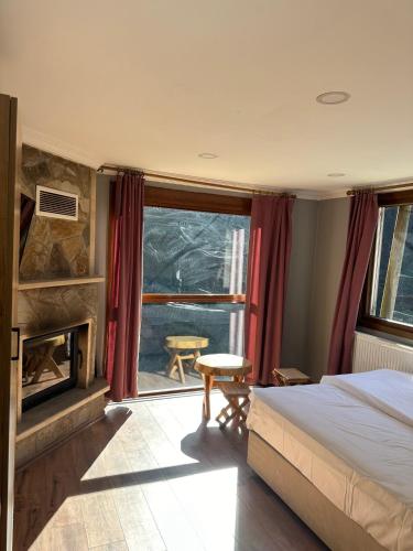 a bedroom with a bed and a fireplace at Ayder Haylaz otel in Çamlıhemşin