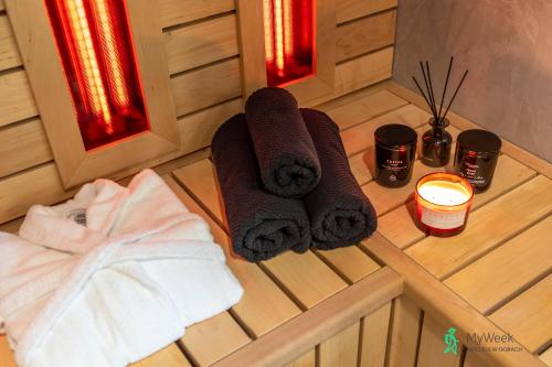 a sauna with towels and candles on a wooden floor at Dom w Starkowie, Basen i Sauna 