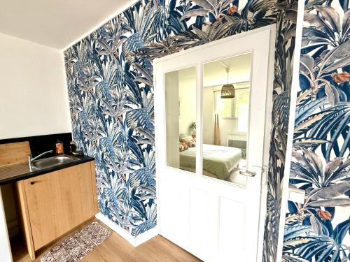 a bathroom with blue and white wallpaper at La Bella Vita Briochine, cosy appartement in Saint-Brieuc